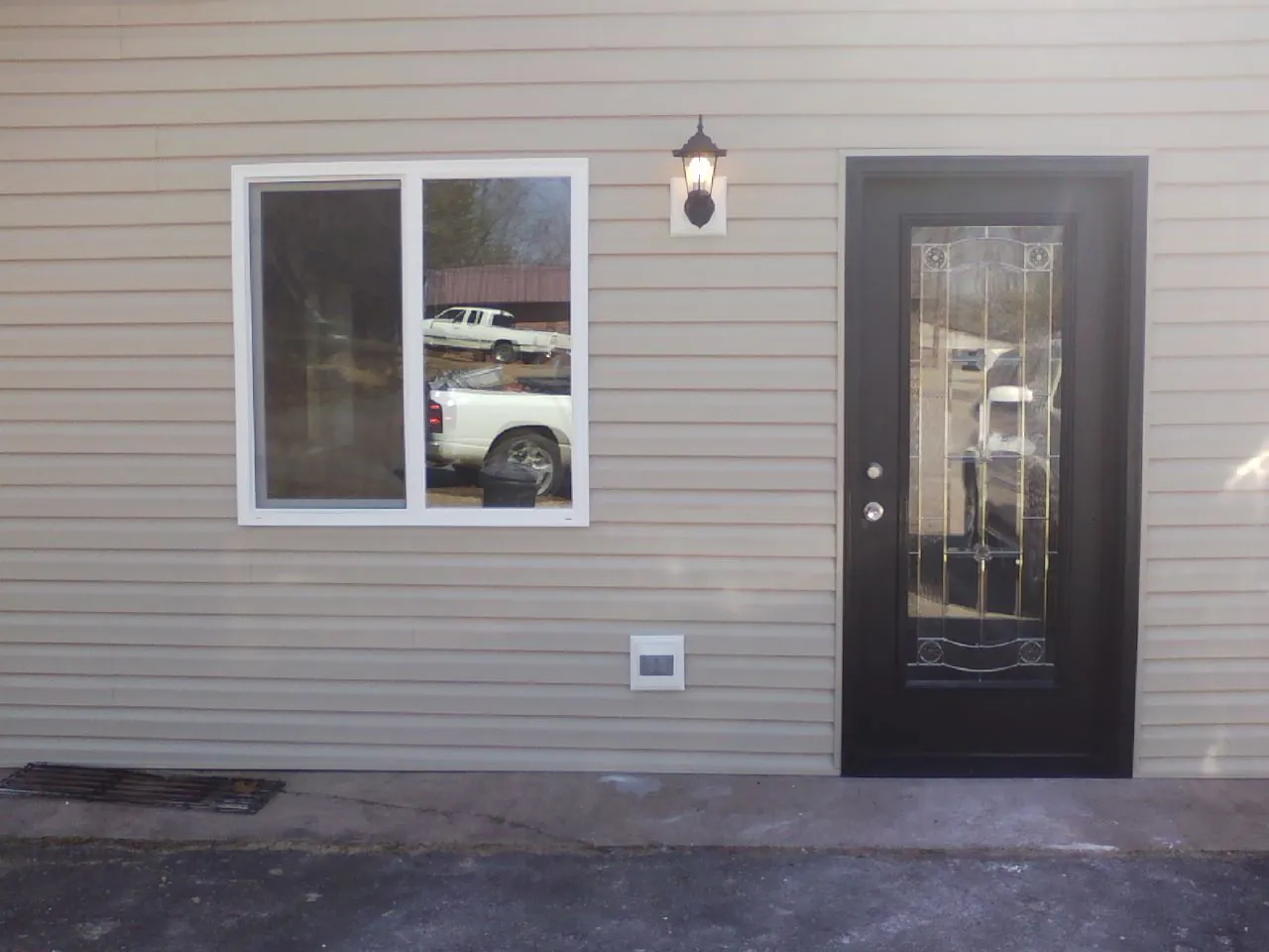 New siding, window and entry door on the side of an addition in Bobtown