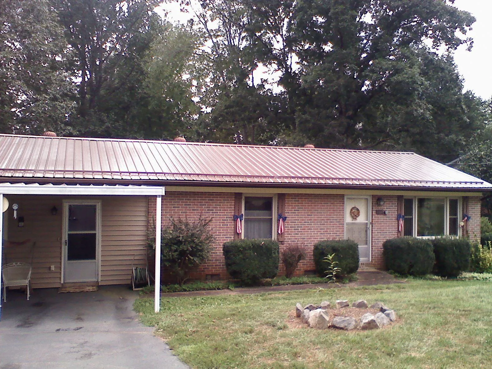 Bronze metal roof and carport on a brick ranch home — Roof Repair work by our crew in Bobtown