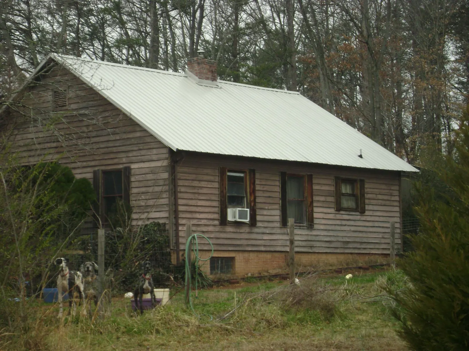 White metal roof on an old wood sided farmhouse, from a Metal Roof Installation job in Bobtown